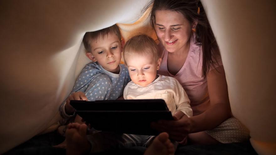 mp62627771-happy-family-in-pajamas-browsing-internet-and-watching